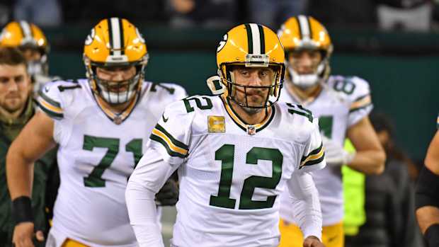 Quarterback Aaron Rodgers leads the Packers' offense onto the field